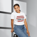Load image into Gallery viewer, Woman wearing a white t-shirt with text design, sitting on a stool against a light background