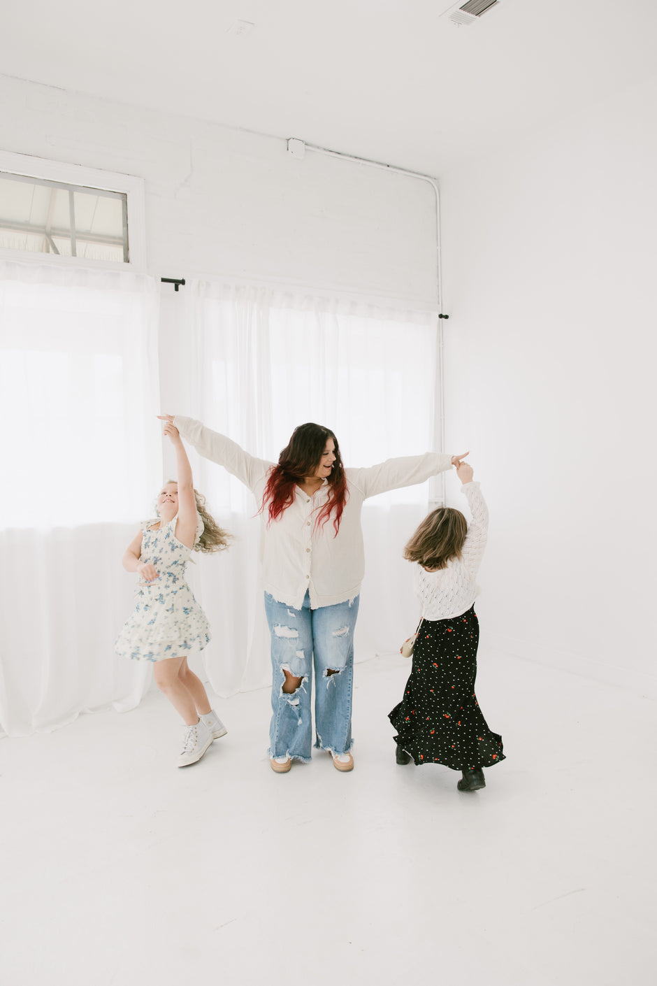 Kaitlin and her kids twirling on her fingers - Photography by Allie Nelson